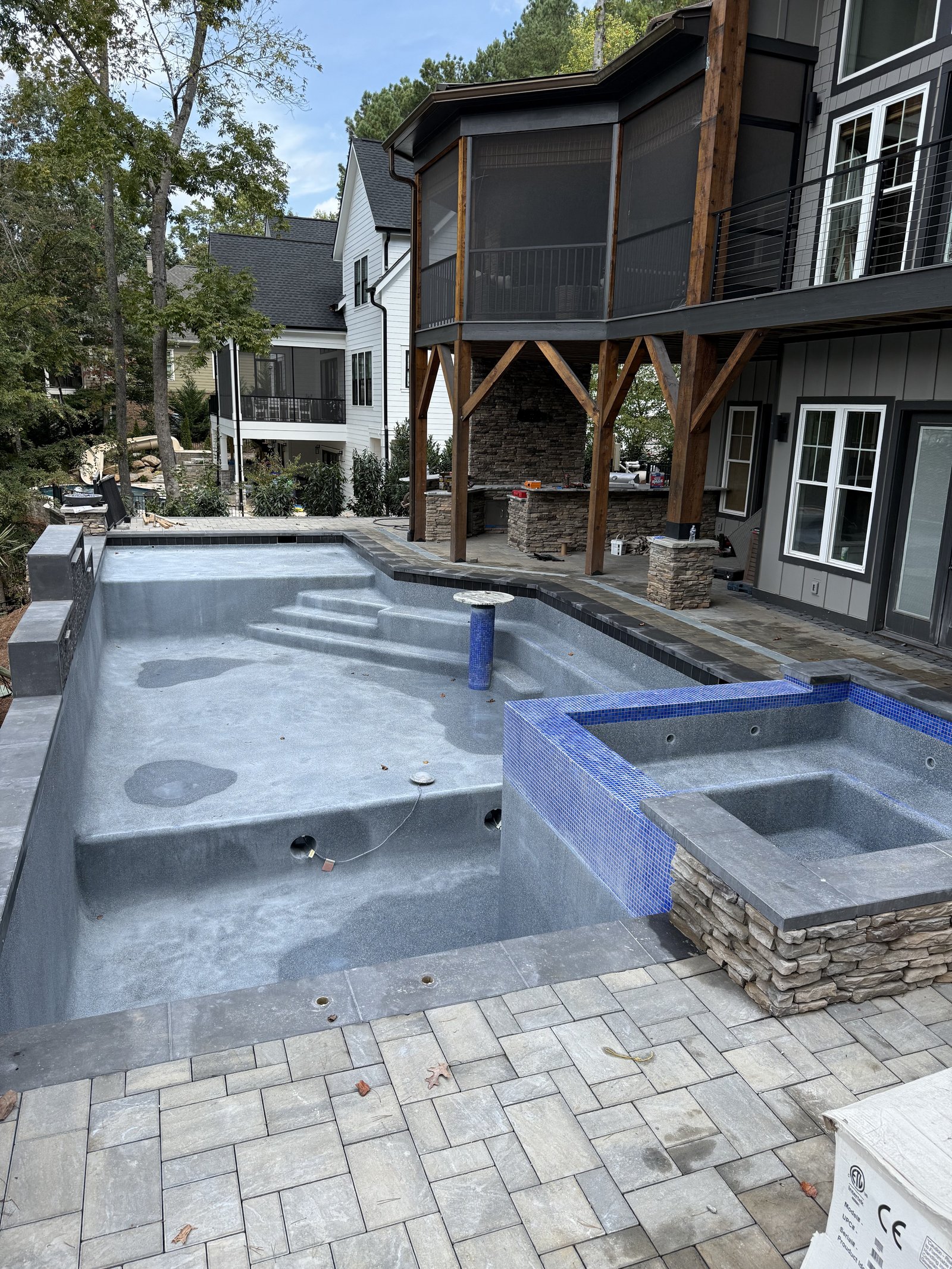 Near-complete pool with spa and stone surround